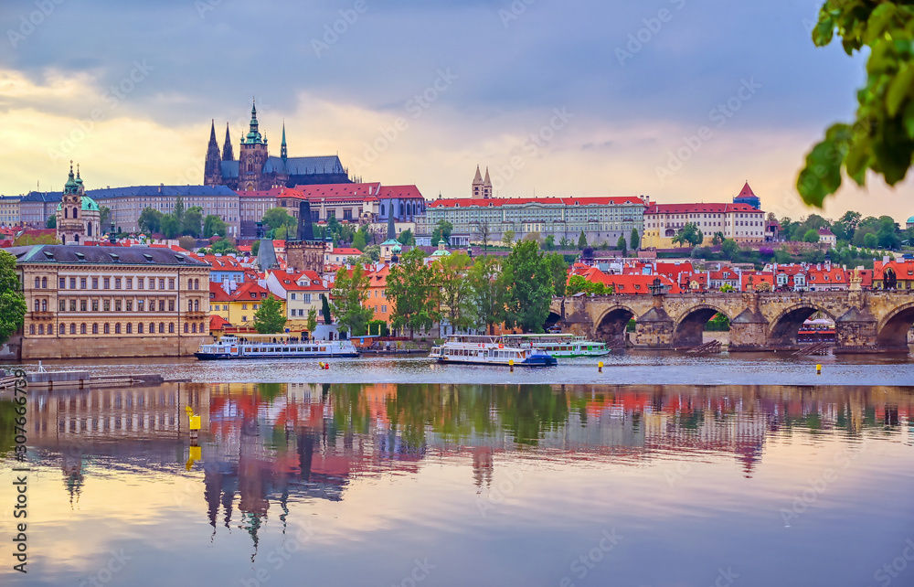 Fototapeta premium A view of Prague Castle and the Charles Bridge across the Vltava River in Prague, Czech Republic.