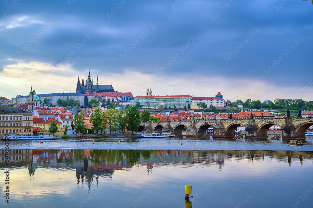 Naklejka premium A view of Prague Castle and the Charles Bridge across the Vltava River in Prague, Czech Republic.