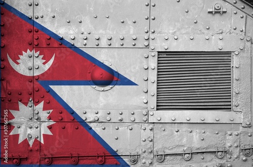 Nepal flag depicted on side part of military armored tank closeup. Army forces conceptual background photo