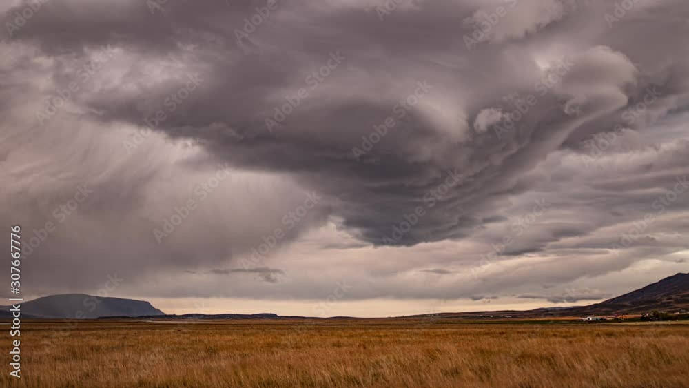 Rain from dark storm clouds over Icelandic farmland time lapse Rain from dark storm clouds over Icelandic farmland time lapse