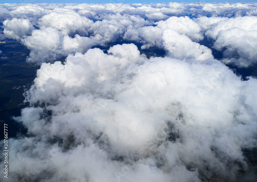 Clouds above the ground view from an airplane as a background