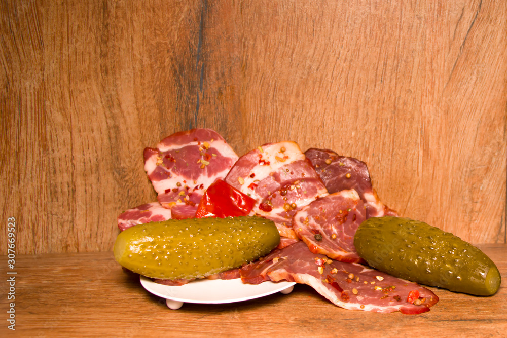 Cured meat appetizer. Pickled Cucumber. Old wood background. Cured meat appetizer. Pickled Cucumber. Old wood background.