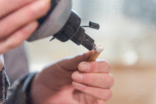 apply glue to dowels. man puts glue on dowels.