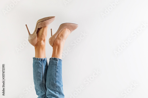 Obraz na plátně Legs with high heels against a white background