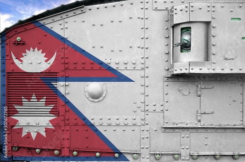 Nepal flag depicted on side part of military armored tank closeup. Army forces conceptual background photo