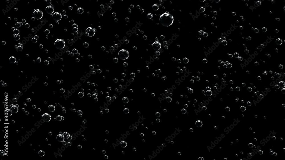 Slowly rising bubbles of champagne on a black background. High density carbon dioxide bubbles. Slowly rising bubbles of champagne on a black background. High density carbon dioxide bubbles.