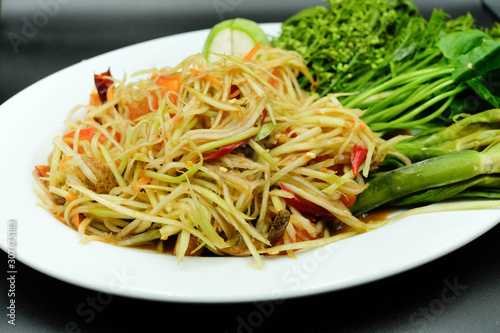 Thai style papaya salad with chilli  tomato and eggplant beside with varity of vegetable using as traditional food and asian hot dish concept.