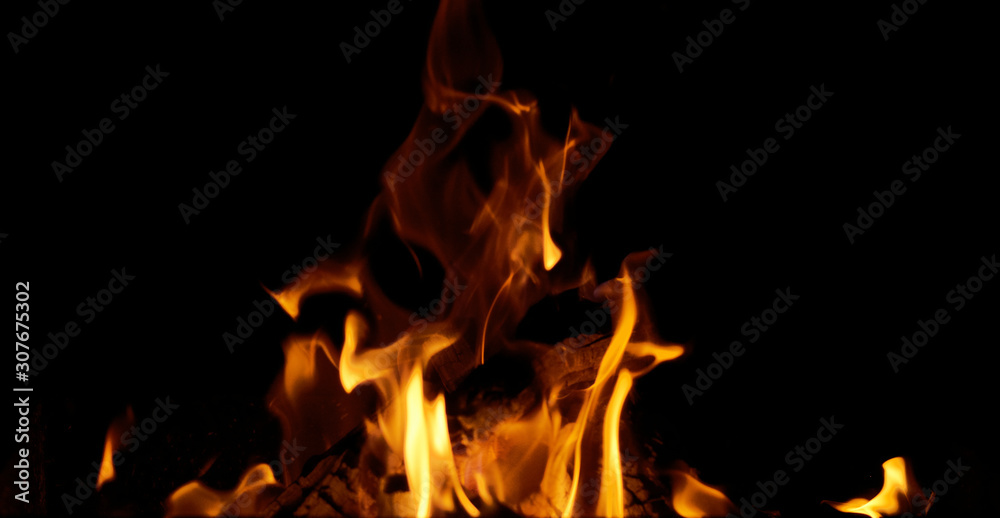 bright orange and yellow flames with sparks on black background bright orange and yellow flames with sparks on black background