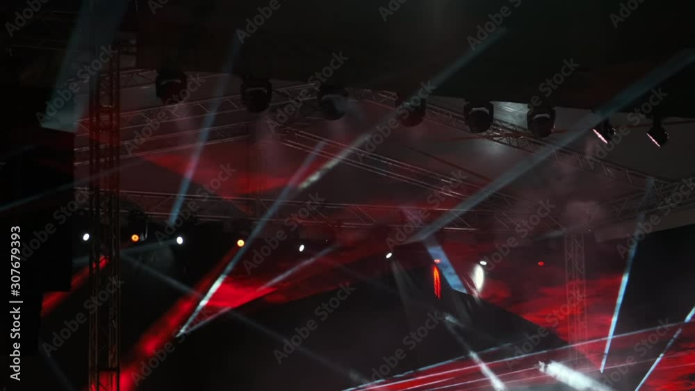 Laser lights on stage major rock concert. Flashing colored laser show