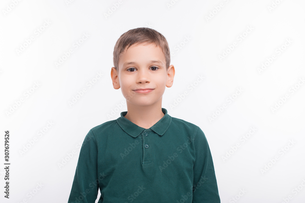 Portrait of happy boy standing over white background and looking confident at the camera Portrait of happy boy standing over white background and looking confident at the camera