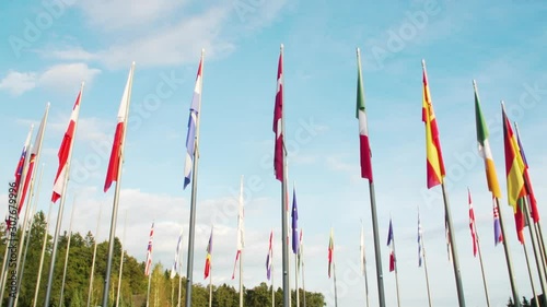 Wide shot, peacefully waving all flags of European Union member states on a warm sunny day, EU countries. photo