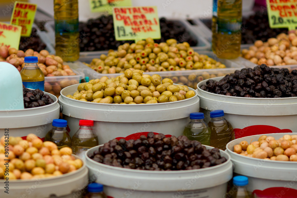 Different olives and olive oil on display at farmer's market