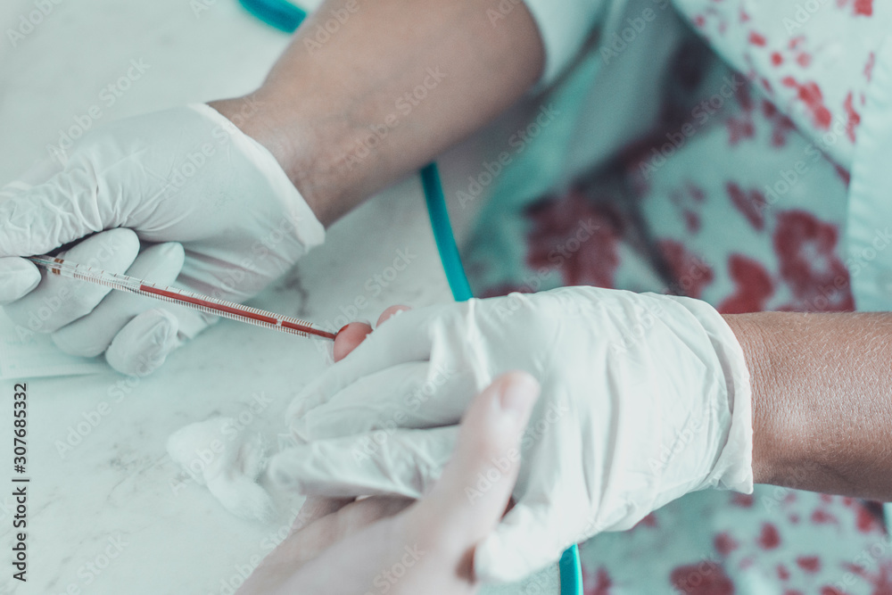Patient blood sampling by a laboratory technician for general blood testing. Patient blood sampling by a laboratory technician for general blood testing.