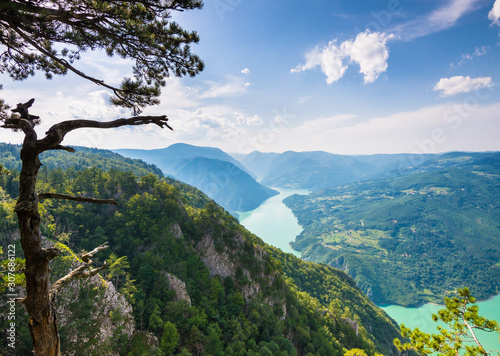 Views of green hills and beautiful lake while trekking in Tara national park in Serbia