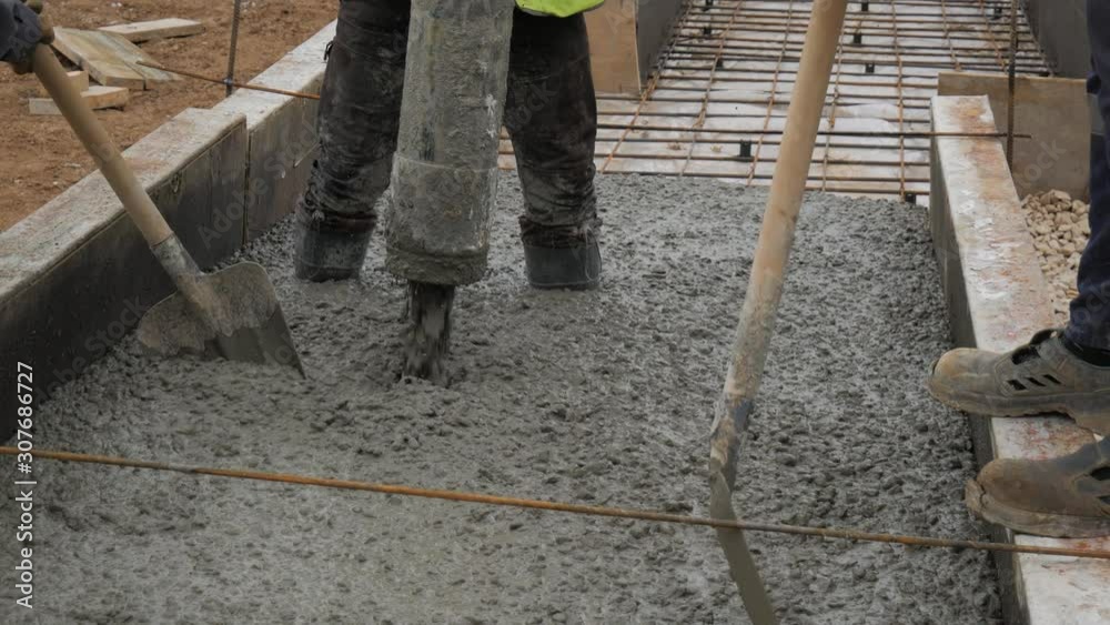 Pouring concrete mix from cement mixer on concreting formwork. Finished leveling the slab and pouring the concrete basement floor. 4K Pouring concrete mix from cement mixer on concreting formwork. Finished leveling the slab and pouring the concrete basement floor. 4K