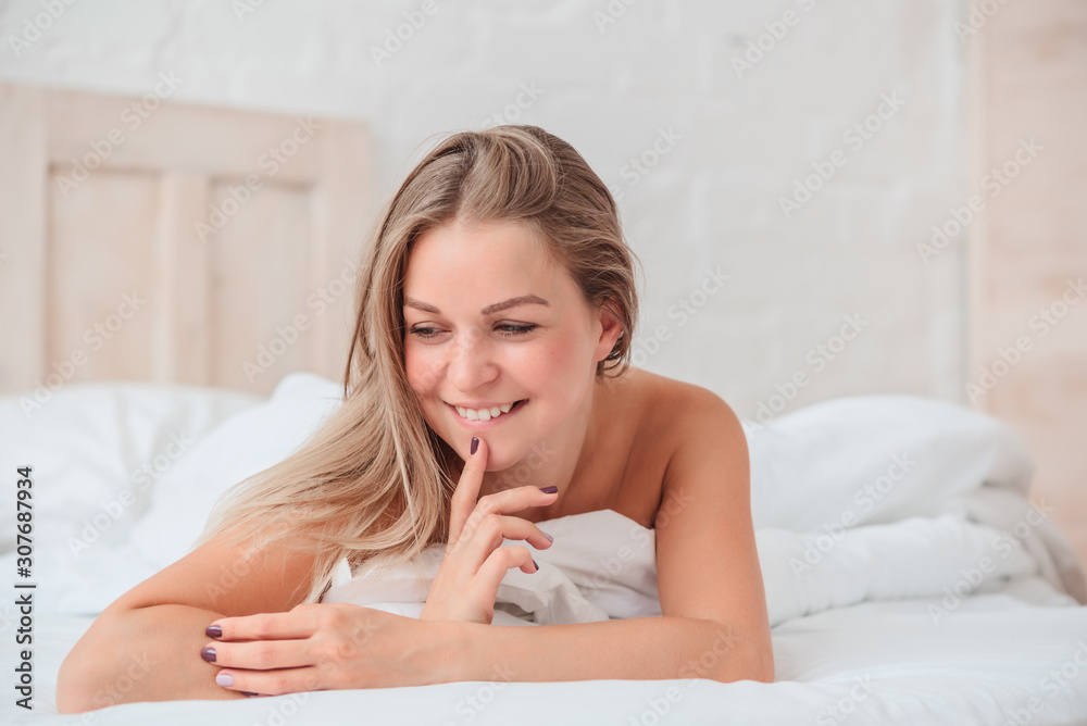 Beautiful blonde woman with long hair in bed, portrait Beautiful blonde woman with long hair in bed, portrait