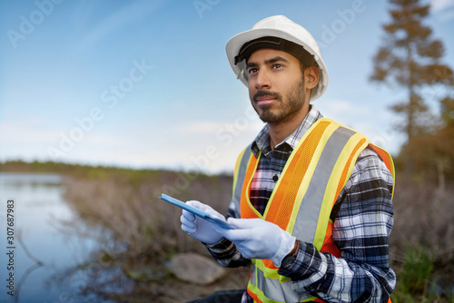 Marine biologist analysing water test results on a tablet in Can
