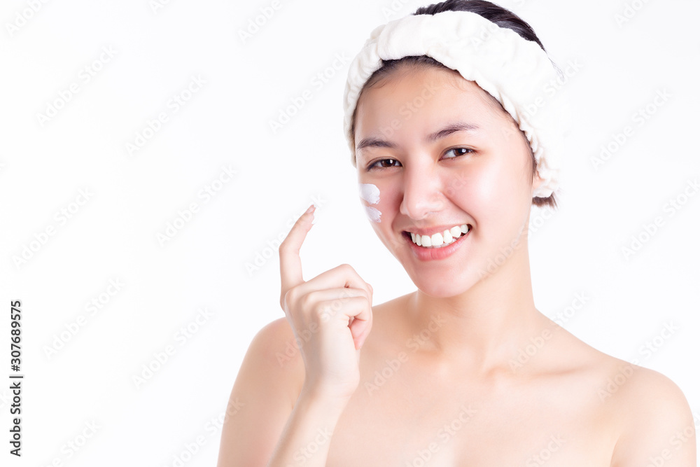 Asian woman apply cream, lotion to beautiful skin on face in bathroom. Young woman hold cream, apply moisturizer on face. Smiling Asia beautiful girl get happiness. She has nice skin. Skincare concept Asian woman apply cream, lotion to beautiful skin on face in bathroom. Young woman hold cream, apply moisturizer on face. Smiling Asia beautiful girl get happiness. She has nice skin. Skincare concept