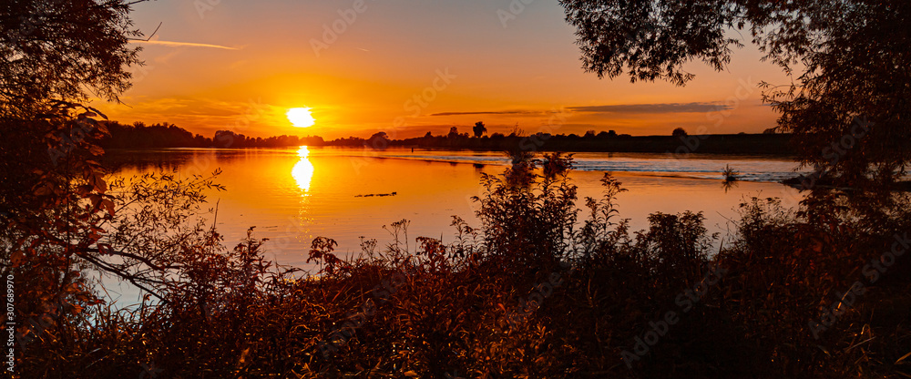 Beautiful sunset with reflections near Mettenufer, Danube, Bavaria, Germany Beautiful sunset with reflections near Mettenufer, Danube, Bavaria, Germany