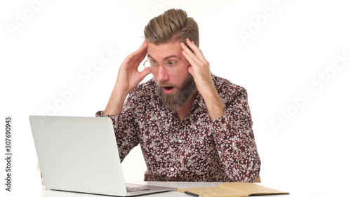 Quadro em tela Man with beard in flowery pattern shirt can't believe whats happening sitting in front of computer