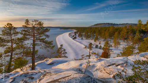 panoramic view from the mountain to the winter beach and forest on the island of Koyonsaari in Lake Ladoga in Karelia