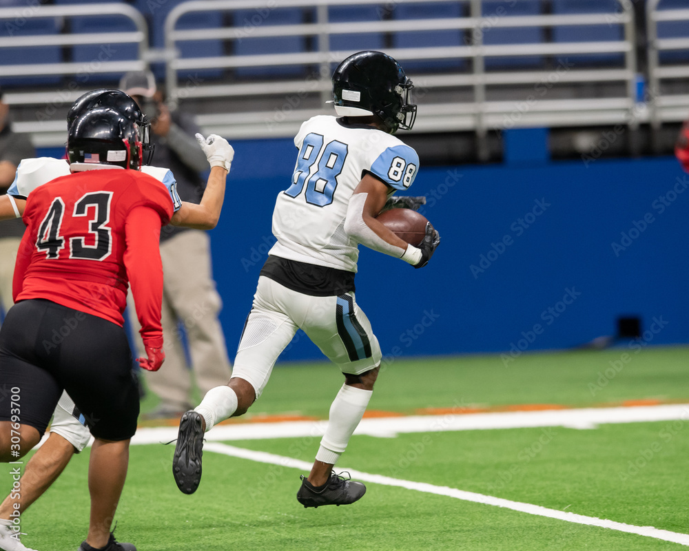 Fototapeta premium Great action photos of high school football players making amazing plays during a football game