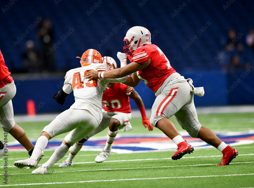 Fototapeta premium Great action photos of high school football players making amazing plays during a football game
