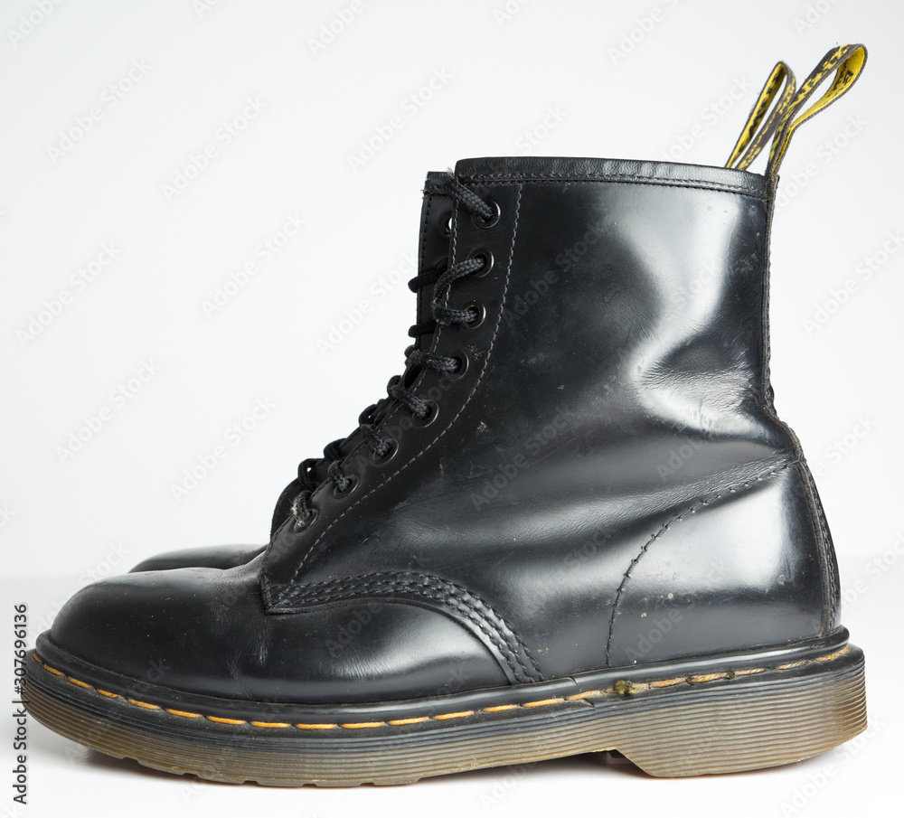 london, england, 05/05/2019 Dr Martens 1460 Black Leather Boots 8 Eye lace  hole. fashionable punk historic british made leather boots. dr martens air  war with bonding soles. built to last. Photos | Adobe Stock