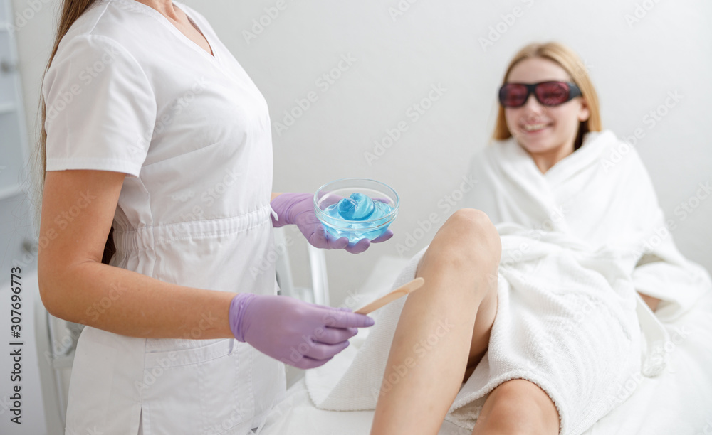 Naklejka premium laser epilation and sugaring in beauty salon