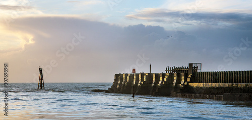 Light beacon and breakwater at Rye Harbour, Sussex, England