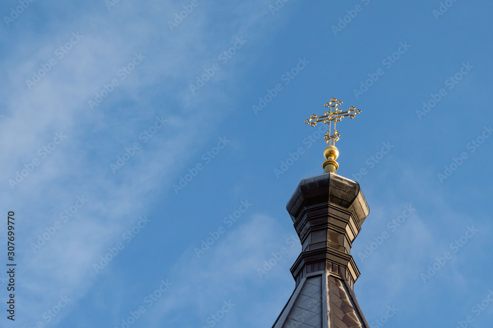 Orthodox church under restoration against the blue sky from the bottom up.