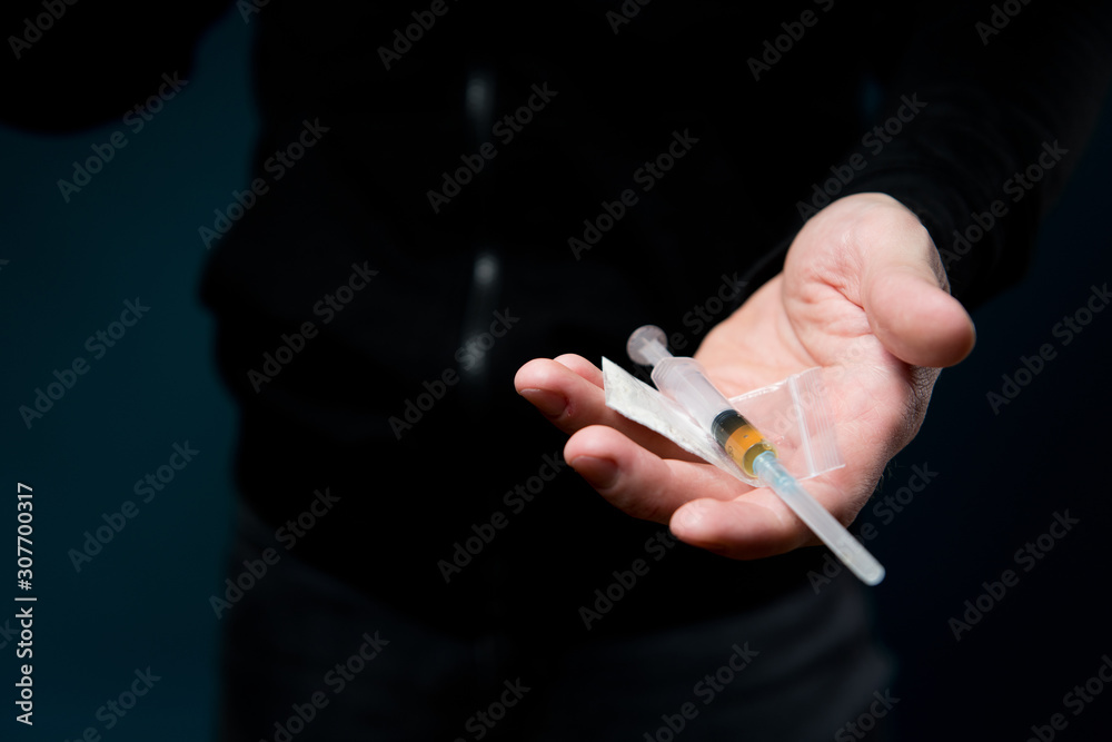 Man holds out his open palm with drugs Man holds out his open palm with drugs