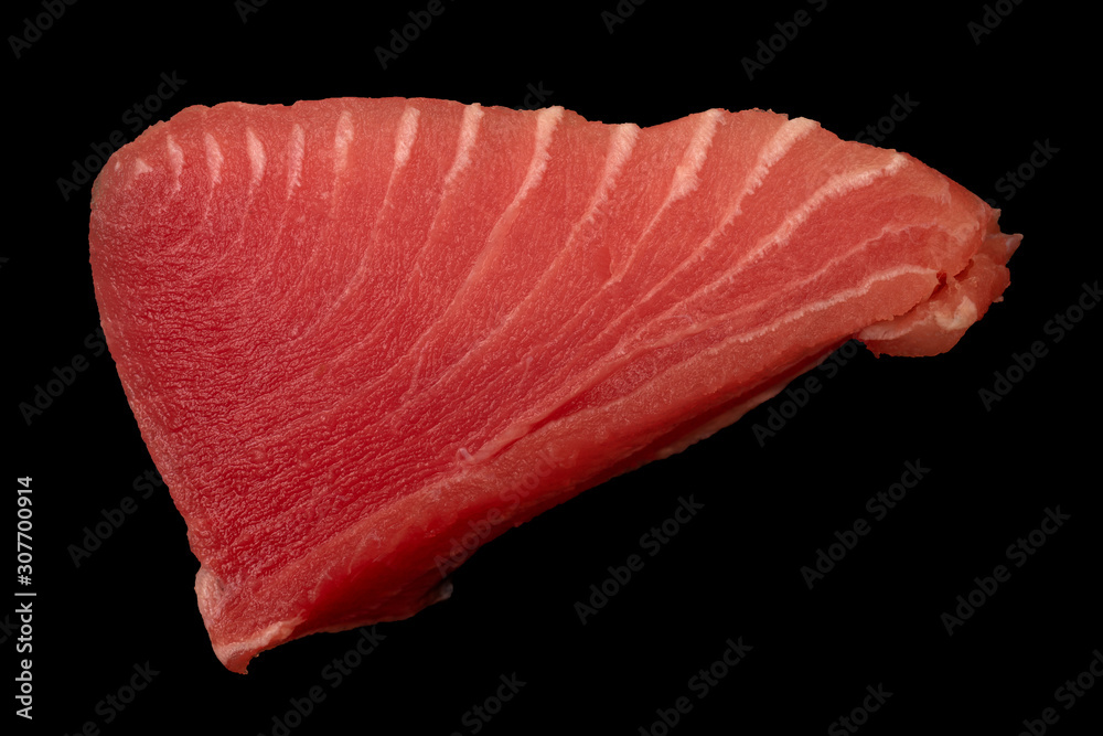 Tuna fillet on black background. Seafood cooking. Useful and tasty food. Tuna fillet on black background. Seafood cooking. Useful and tasty food.