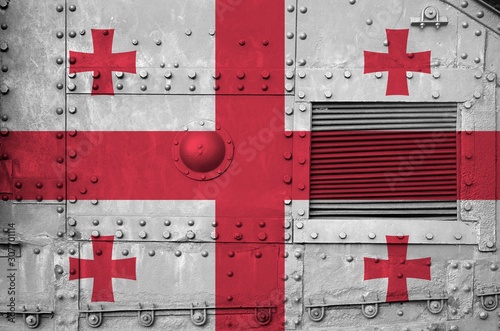 Georgia flag depicted on side part of military armored tank closeup. Army forces conceptual background photo