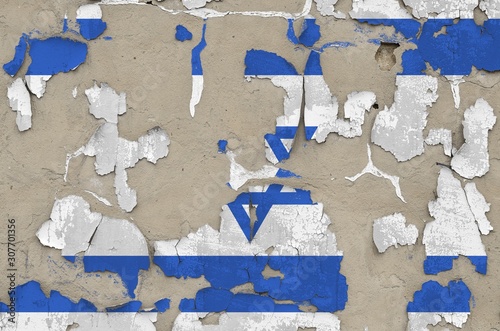 Israel flag depicted in paint colors on old obsolete messy concrete wall closeup. Textured banner on rough background photo