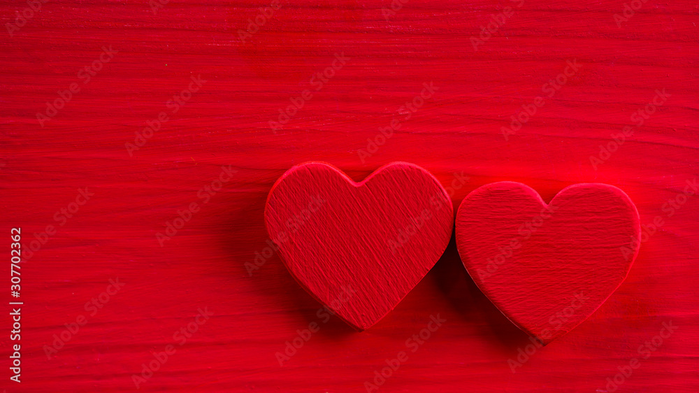 Two red heart on the red wooden table. Valentine's Days background. Empty with copy space for ad text Two red heart on the red wooden table. Valentine's Days background. Empty with copy space for ad text