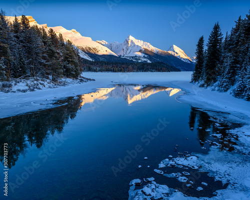 The frozen Maligne Lake with Queen Elizabeth Ranges in the background in the Jasper National Park