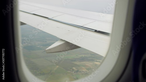 Wing flaps of the airplane turbulence window aerial view