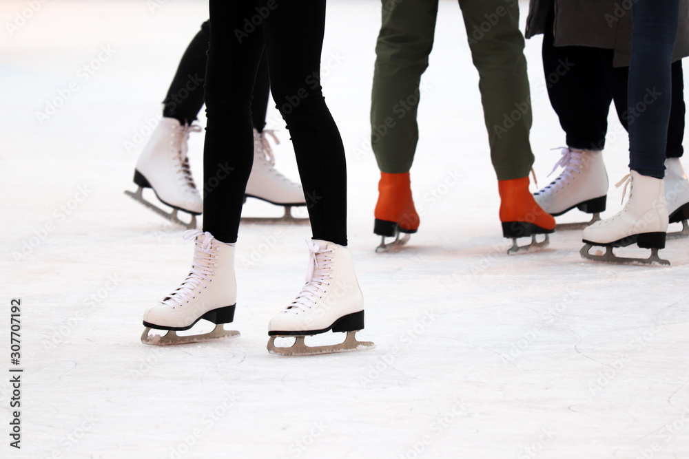 Ice skating, female feet at the ice rink. Girls in the skates, winter sports and fun Ice skating, female feet at the ice rink. Girls in the skates, winter sports and fun