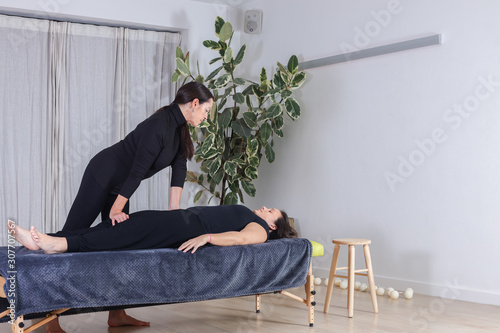 Traditional shiatsu massage done by mature therapist.