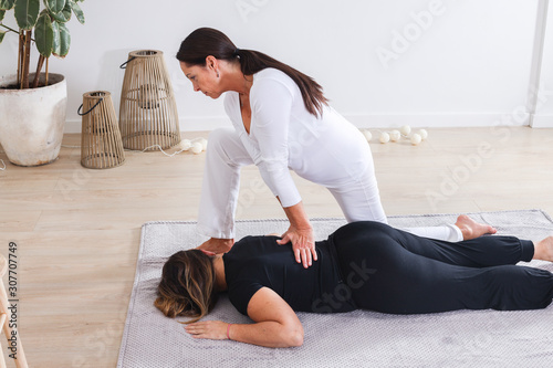 Traditional shiatsu massage done by mature therapist.