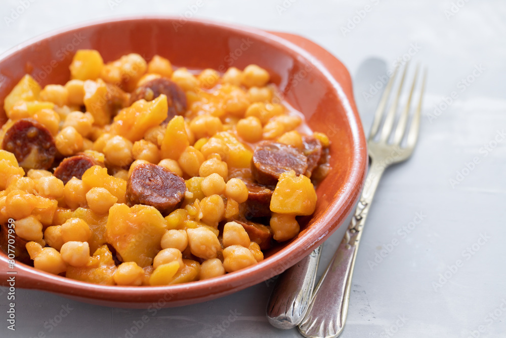 chickpea with potato and smoked sausage on ceramic dish