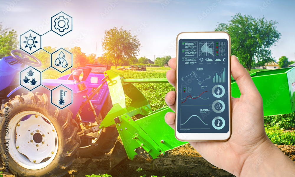 Farmer holds smartphone with infographic on tractor background with ...