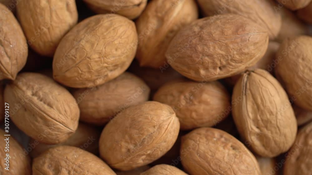 Walnut close up. product rich in minerals and vitamins. Walnut turns in a shot. Walnut kernels rotating. walnut close up lies under beams of the sun. Macro Walnut close up. product rich in minerals and vitamins. Walnut turns in a shot. Walnut kernels rotating. walnut close up lies under beams of the sun. Macro