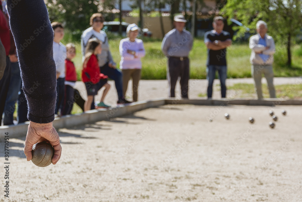 Naklejka premium Senior people playing bocce in a park