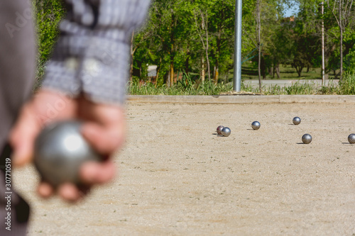 Senior people playing bocce in a park