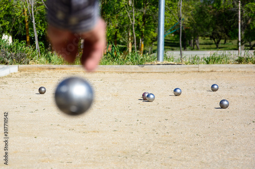 Senior people playing bocce in a park