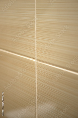 Wall texutra made of beige tile.