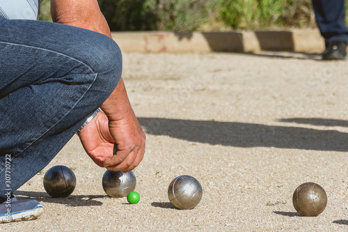 Senior people playing bocce in a park