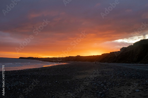 sunset on stoney beach northern ireland